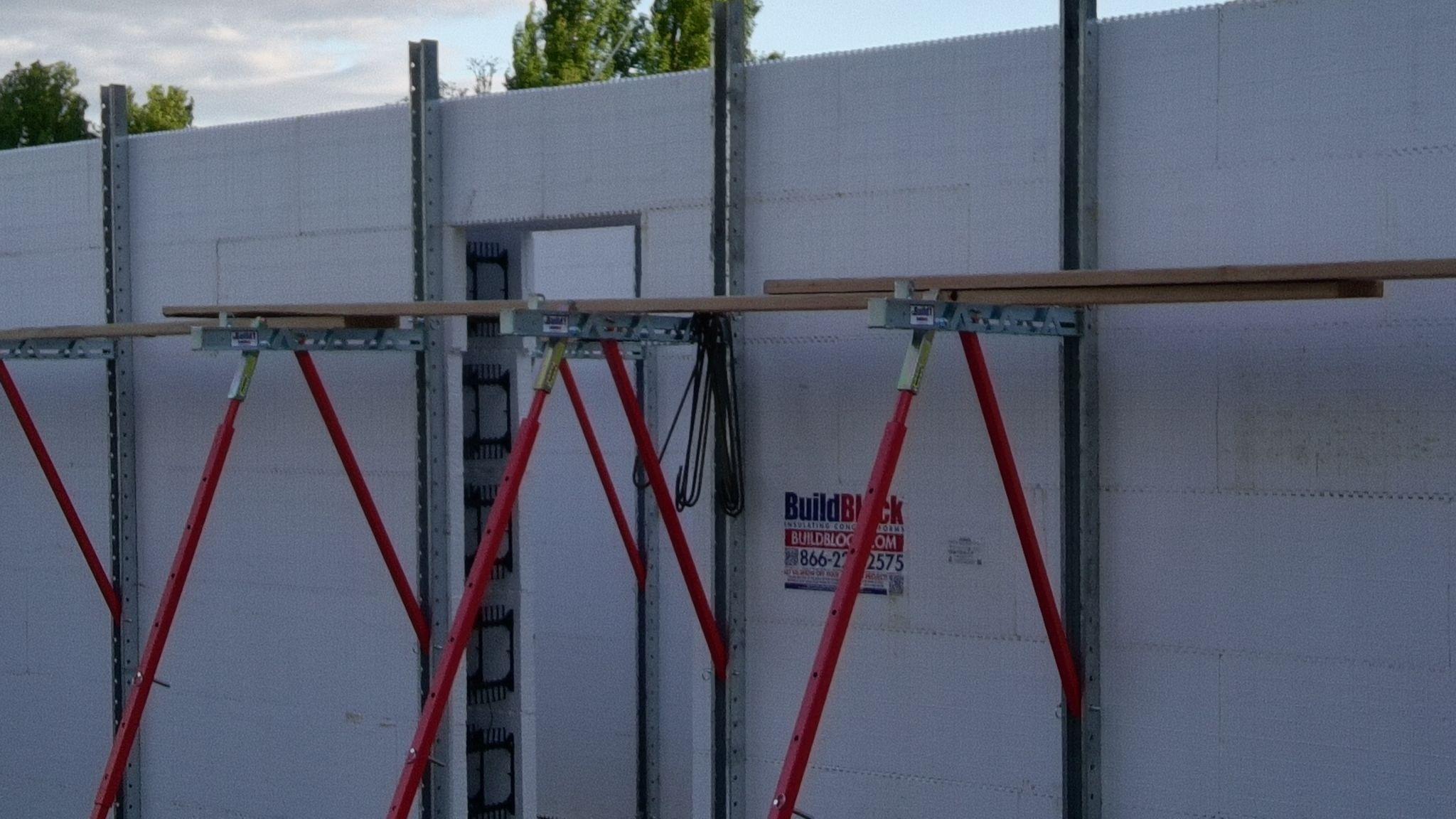 ICF wall bracing with a door buck, walkboard and red turnbuckle braces